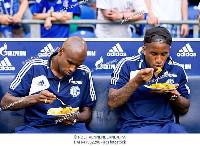 Schalke's Felipe Santana (L) and Jefferson Farfan eat paella after the farewell match for Raul betweeen FC Schalke 04 and Al-Sadd at Veltins Arena...