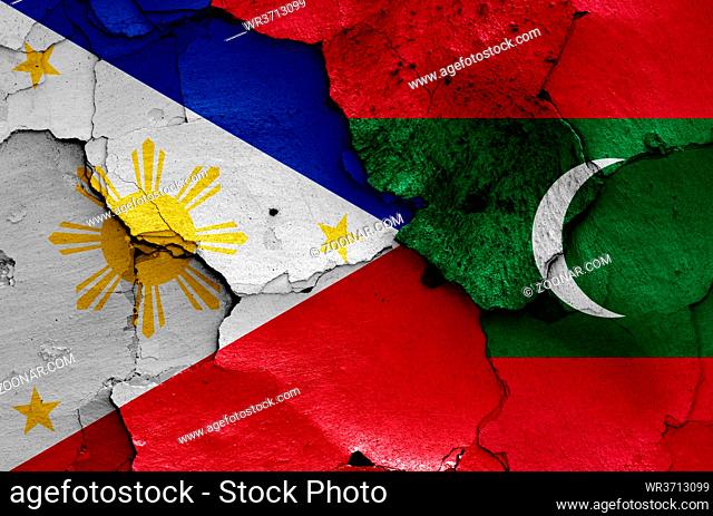 flags of Philippines and Maldives painted on cracked wall