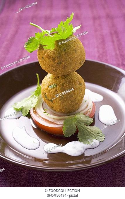 Falafel chick-pea balls with tomato and yoghurt sauce