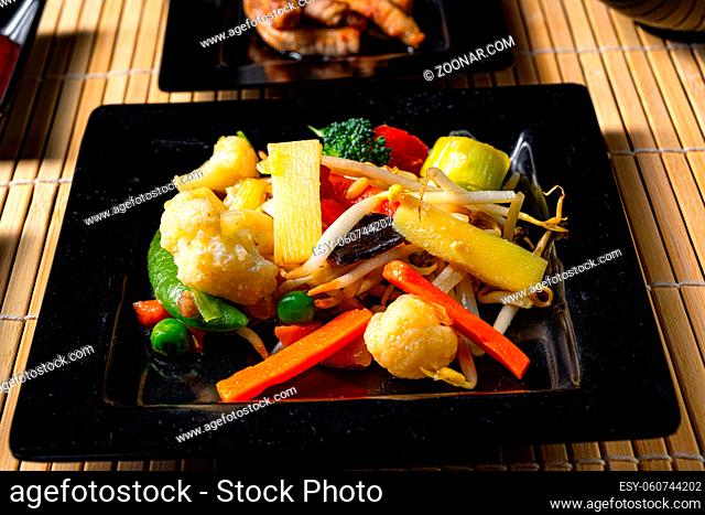 Fried vegetables from the wok with deep fried meat