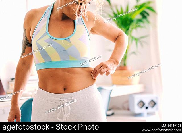 concept of body disappointing with young caucasian woman holding belly fat and looking sad. active female people and weight loss diet concept lifestyle...
