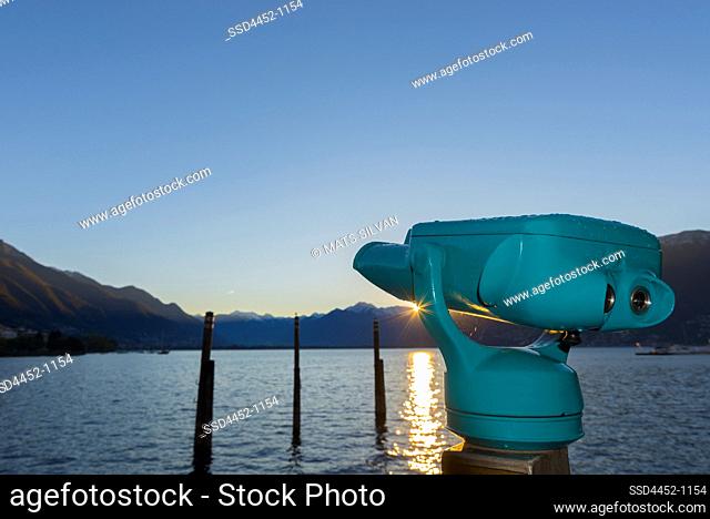 Telescope over Alpine Lake Maggiore with Mountain and Sunset in Locarno, Switzerland
