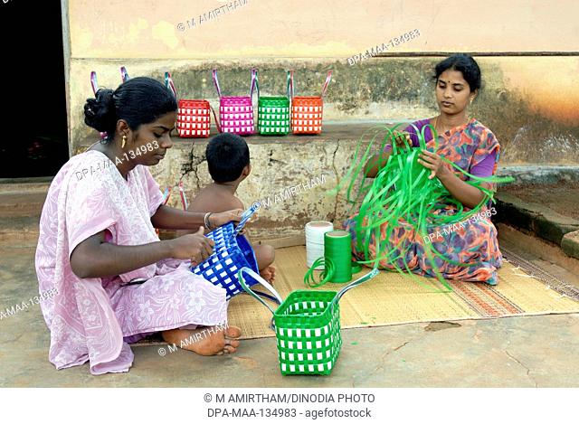 Cottage industry; woman weaving plastic strips baskets ; Tamil Nadu ; India