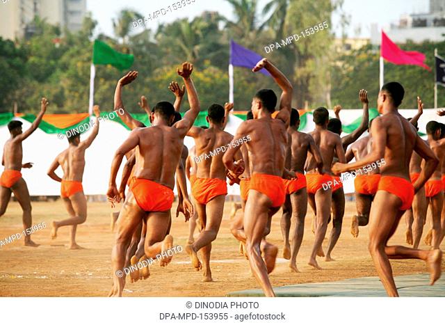 Police men waving after performing Malkhamb Indian gymnastics on 1 May Maharashtra state foundation day ; Shivaji park ; Dadar ; Bombay Mumbai ; Maharashtra ;...