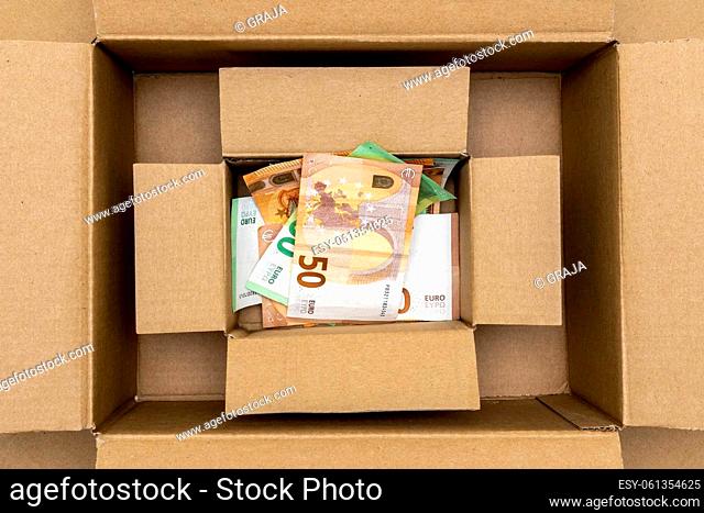 Savings, donations or hidden asset in a cardboard boxes. Boxes with Euro currency. Conceptual image