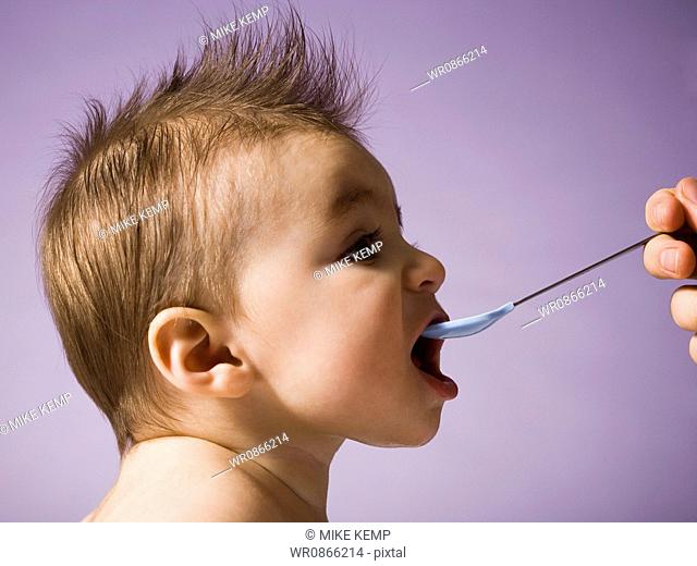 Profile of baby with spoon