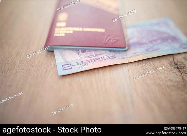 Picture of a Swedish Passport with a Blurry Honduran Lempira Bill partially inside it