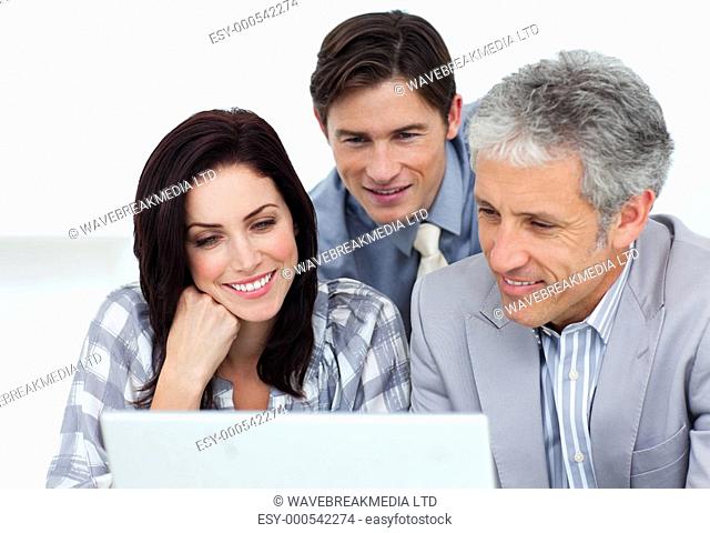 Confident business partners working at a computer in an office
