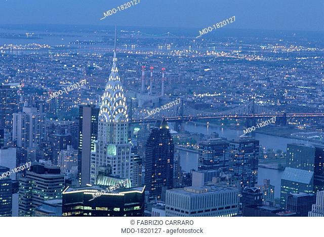 View by night of Manhattan island dominated by the illuminated Art Déco spire of the Chrysler Building. New York (USA), 2000s