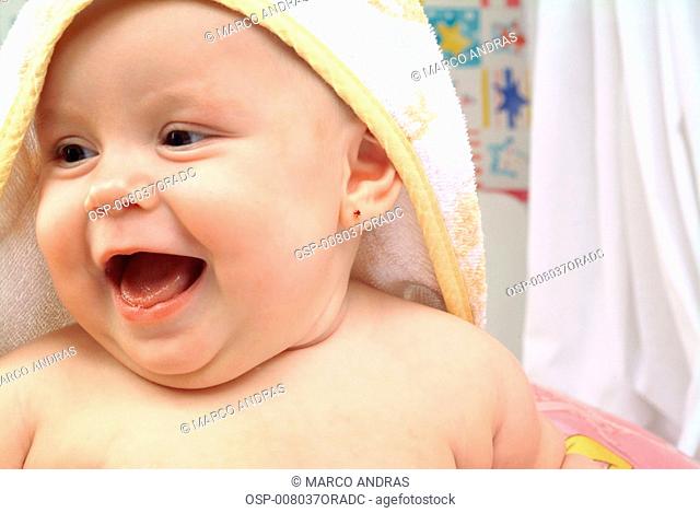 young baby using a wrapped towel on head