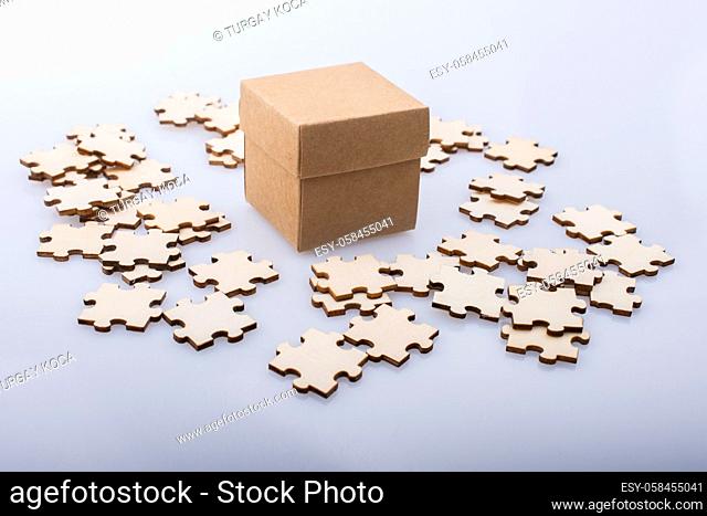 Pieces of jigsaw puzzle around box as problem solution business concept