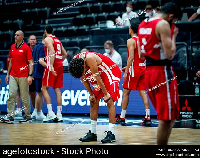 20 June 2021, Hamburg: Basketball: Supercup, Tunisia - Czech Republic, Matchday 3. Tunisia's Belhassan Chihi stands on the court after the match with his head...