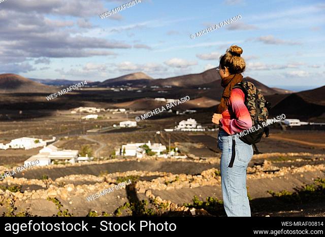 Backpacker looking at scenic mountains
