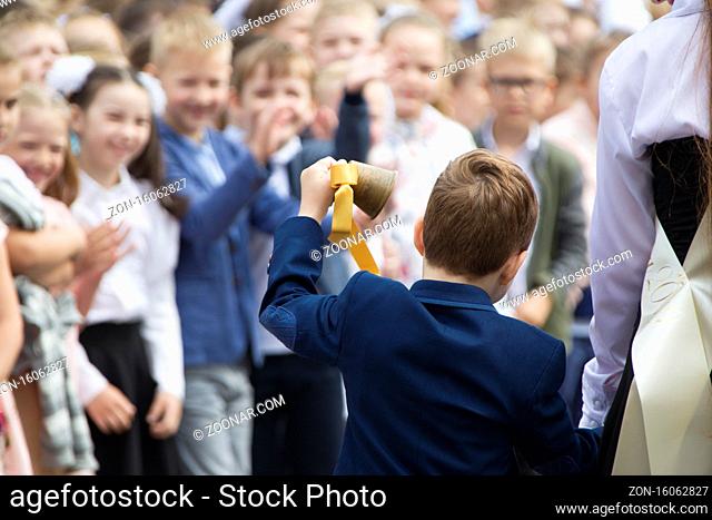 Belarus, Gomel, May 30, 2019 Graduation at school and last bell. Schoolboy boy rings the bell
