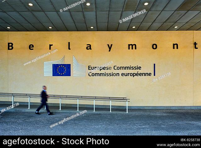 Blurred man walking in front of The Berlaymont building in Brussels, Belgium, which houses the headquarters of the European Commission
