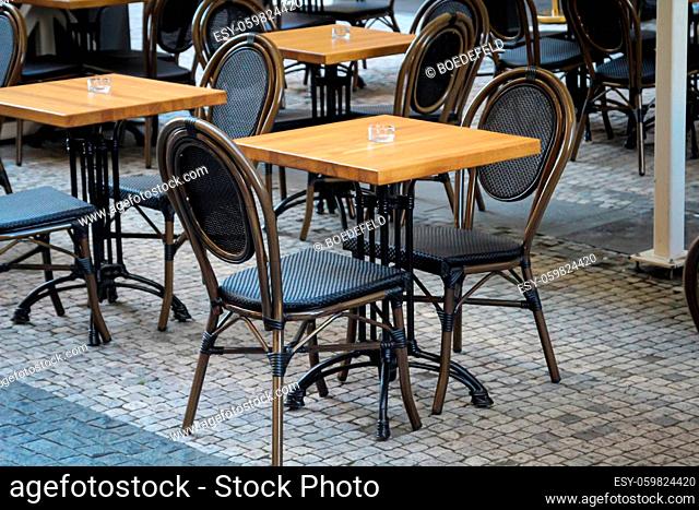 An empty table with two chairs in a restaurant