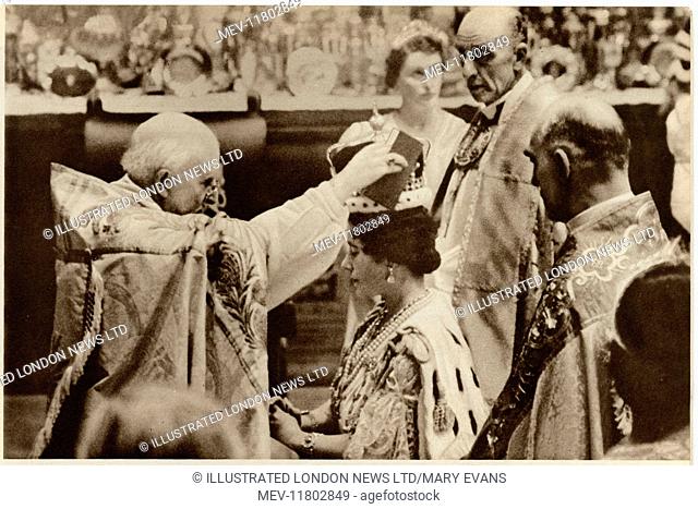 The Queen's Coronation. Her Majesty is kneeling on her faldstool and the Archbishop of Canterbury is placing the Crown upon her head