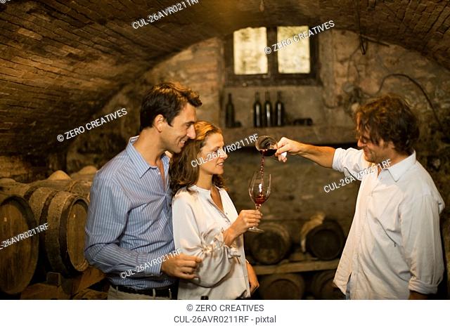 People tasting wine in cellar