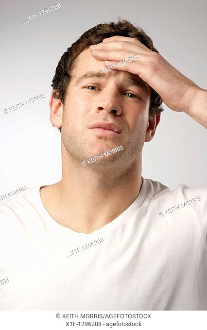 White caucasian male man suffering with a headache sore head hangover