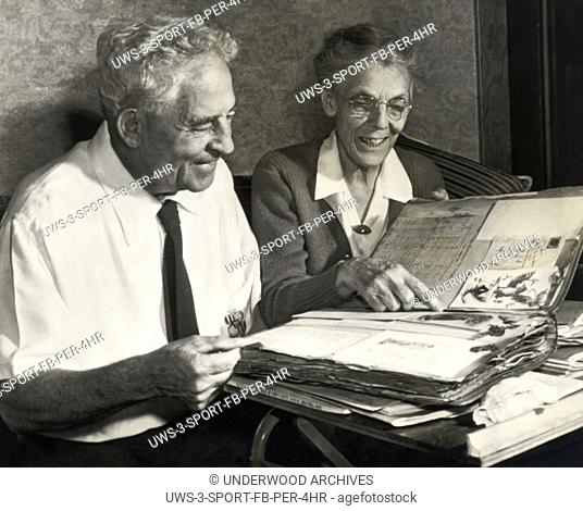 Stockton, California, October 22, 1943 College of the Pacific Tigers football Coach Alonzo Stagg and his wife enjoying looking through their scrap book which he...
