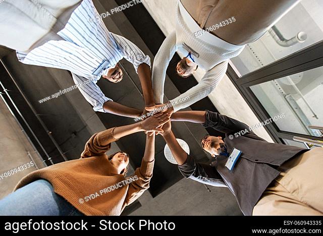 group of business people stacking hands at office