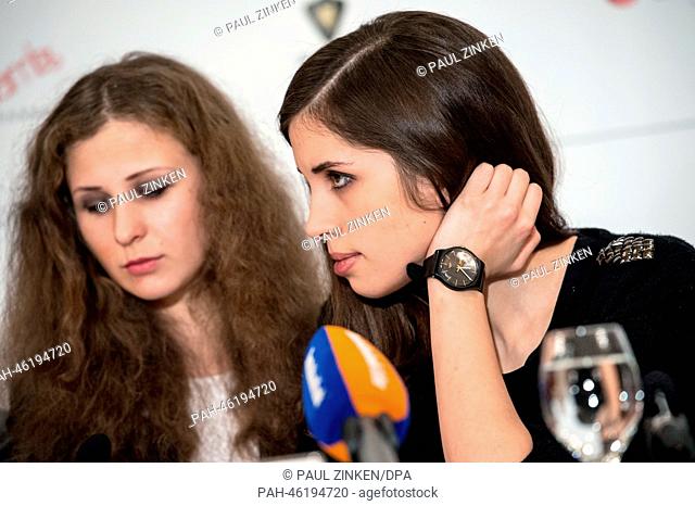 Maria Alyokhina (L) and Nadezhda Tolokonnikova of the Russian band Pussy Riot attend a press conference as part of the Cinema for Peace Gala in Berlin, Germany