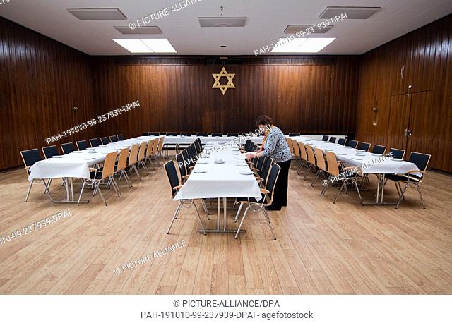 10 October 2019, Lower Saxony, Hanover: A woman is setting tables in rooms at the synagogue in the Jewish Community Hanover in the Haeckelstraße