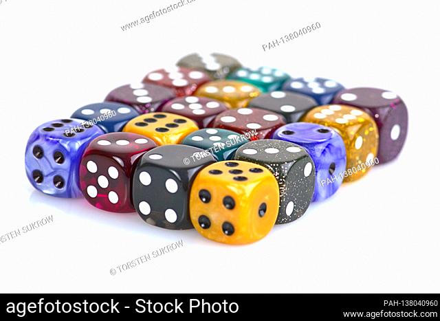 The die is cast"". Colorful dice in a row with a slight reflection on the ground in front of a neutral background. | usage worldwide. - /Deutschland