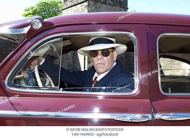 1940 style US government agent in a 1942 Chrysler New Yorker car