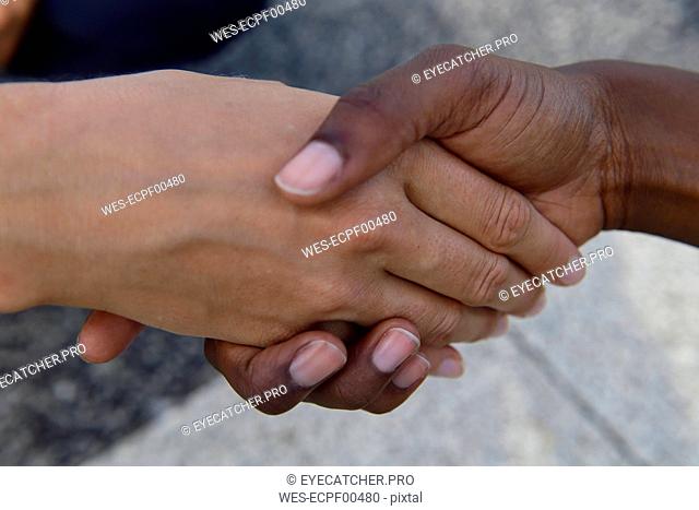 Close-up of two women shaking hands