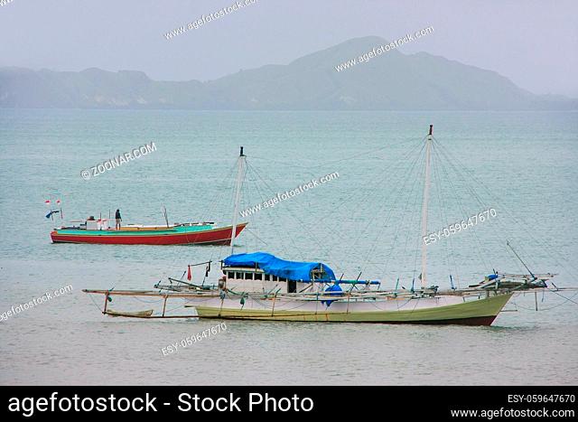 Traditional outrigger boat anchored at Labuan Bajo town on Flores Island, Nusa Tenggara, Indonesia. The local economy in the town is centered around the ferry...