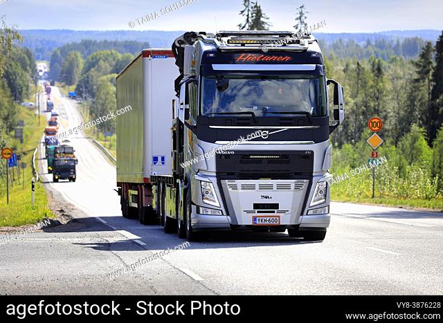 Silver Volvo FH truck of Hietanen Transport Oy pulls trailer in convoy to Power Truck Show 2021. Highway 3, Ikaalinen, Finland. August 12, 2021