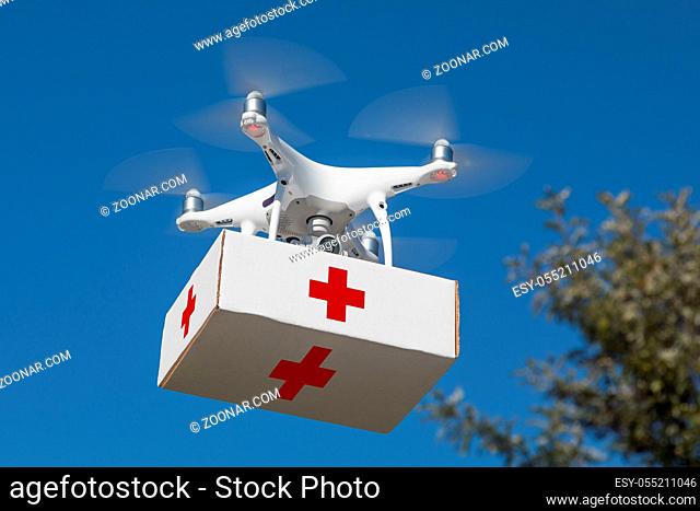 Unmanned Aircraft System (UAS) Quadcopter Drone Carrying First Aid Package In The Air