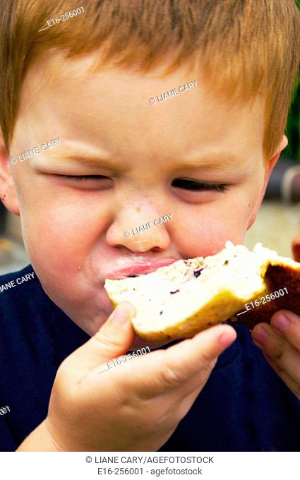 Boy eating bagel