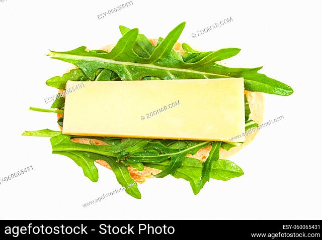 top view of open sandwich with fresh bread, cheese and green arugula leaves isolated on white background