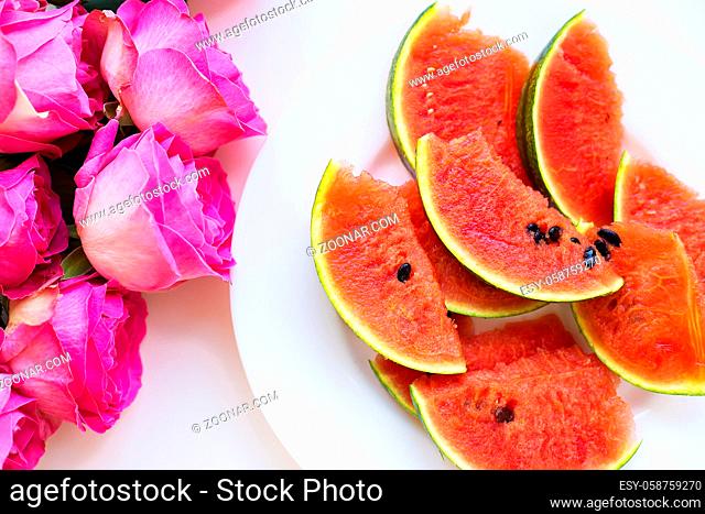 bouquet of pink roses on the table with watermelon