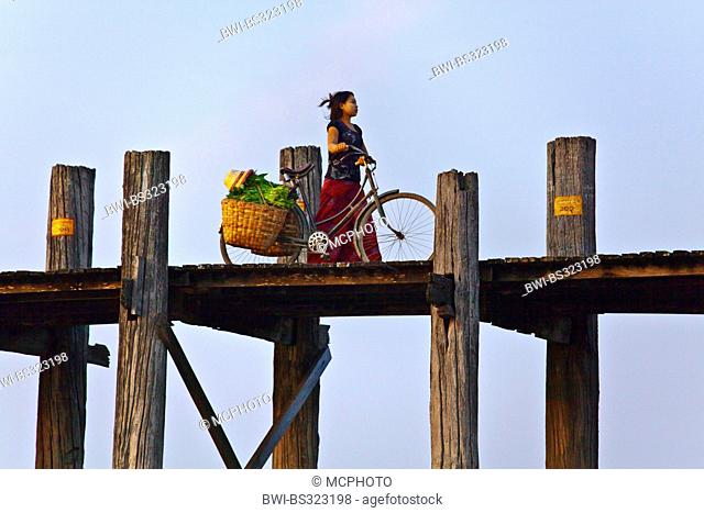 The BURMESE use the teak U BEIN BRIDGE to commute across the Taungthaman Lake at sunrise , Burma, Amarapura