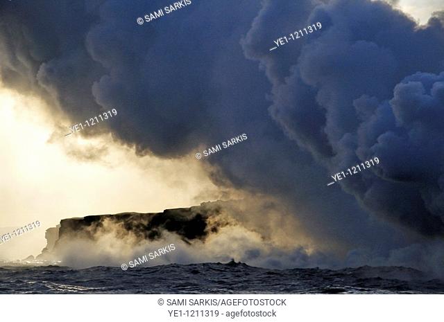 Steam rising off lava flowing into ocean at sunset, Kilauea Volcano, Hawaii Islands, United States