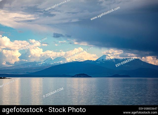 Storms rolling in over Tongariro National Park. The peaks of Mt Ruapehu and Mt Ngaurhoe can be seen at sunset in New Zealand