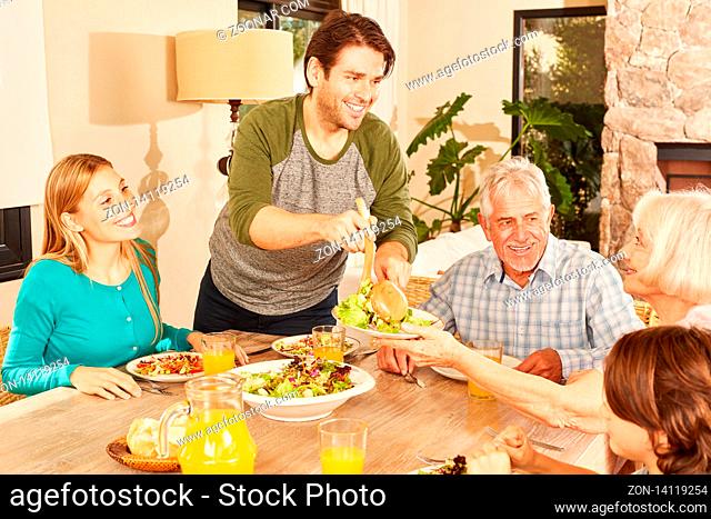 Erweiterte Familie mit Kindern und Großeltern beim Mittagessen zu Hause