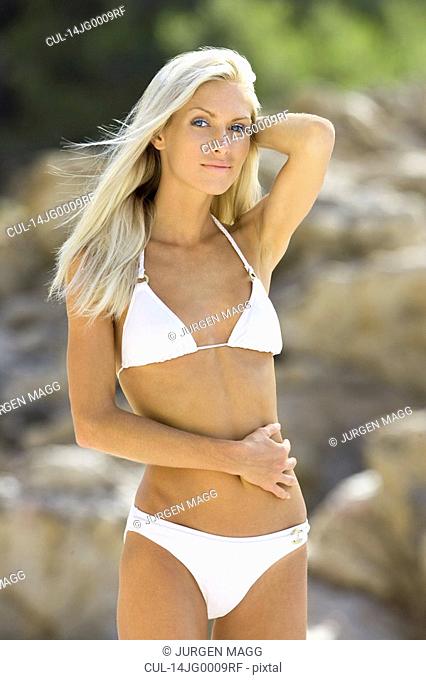 A blond beach girl posing for the camera