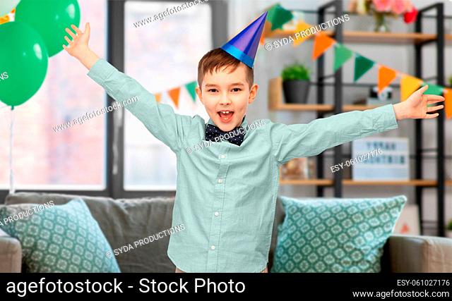 happy little boy in birthday party hat at home