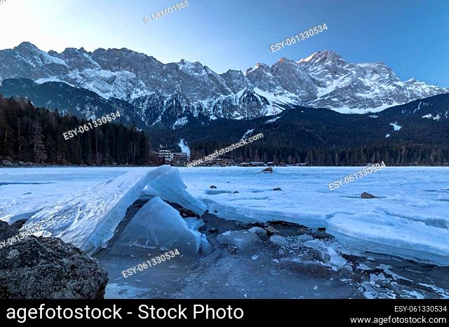 Cold morning at frozen lake Eibsee, Bavaria, Germany, in front of Zugspitze mountain