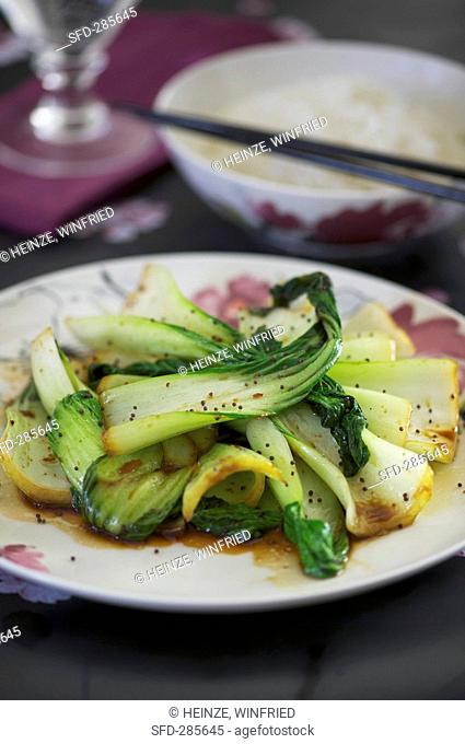 Fried pak choi with side dish of rice Asia