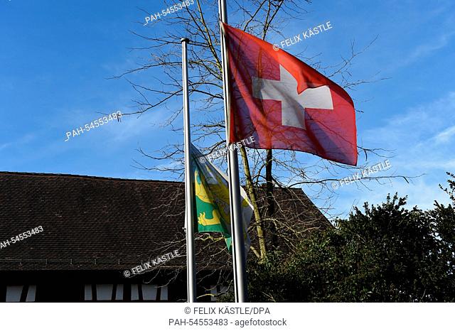 The flags of Switzerland (front) and of the canton of Thurgau (back) fly at half staff in Gottlieben, Switzerland, 22 December 2014