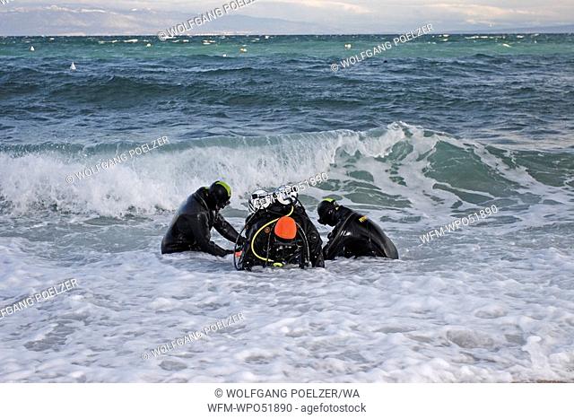 Scuba Diver helping each other in Surf Zone, Istria, Adriatic Sea, Croatia