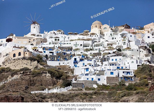 Typical greek village perched on volcanics rock with its white and blue houses and windmills Santorini Cyclades Greece Europe