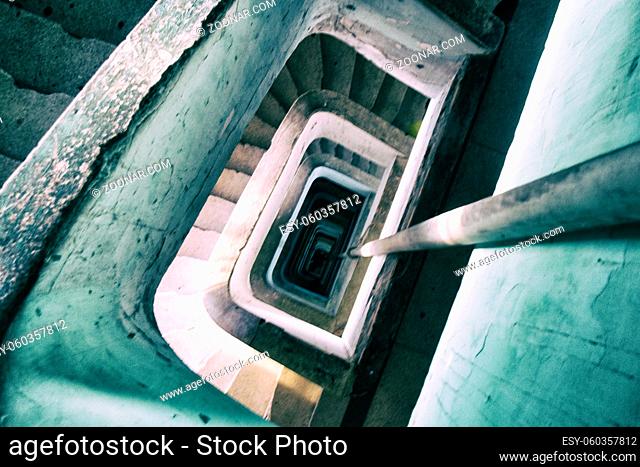 Dangerous spiral stairs in an eroded old building used by a social housing movement
