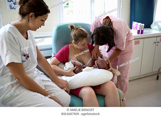 Photo essay at the maternity of the Diaconesses hospital in the 12th district of Paris, France. The child care aid is showing the mother how to do a...