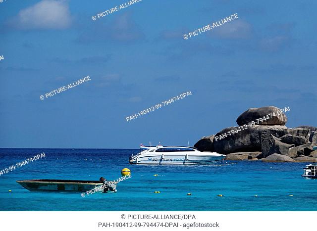 08 March 2019, Thailand, Similan: A speedboat and a motorboat lie in the crystal clear water in front of the beach of the ""Ao Kuerk"" bay on the island of Ko...